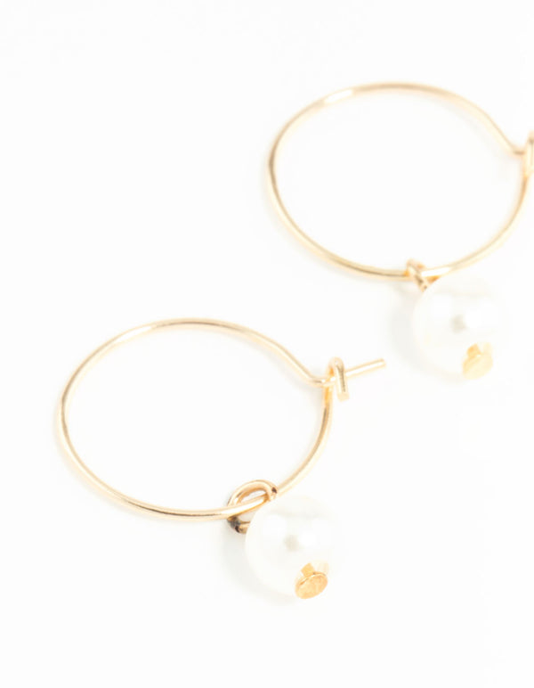 Showcasing dainty hoop earrings 3mm in gold with pearl close up view