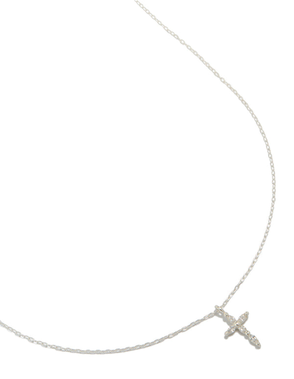 Showcasing a dainty cross necklace crafted from sterling silver with marquise cut cubic zirconia in a delicate pendant design close up view
