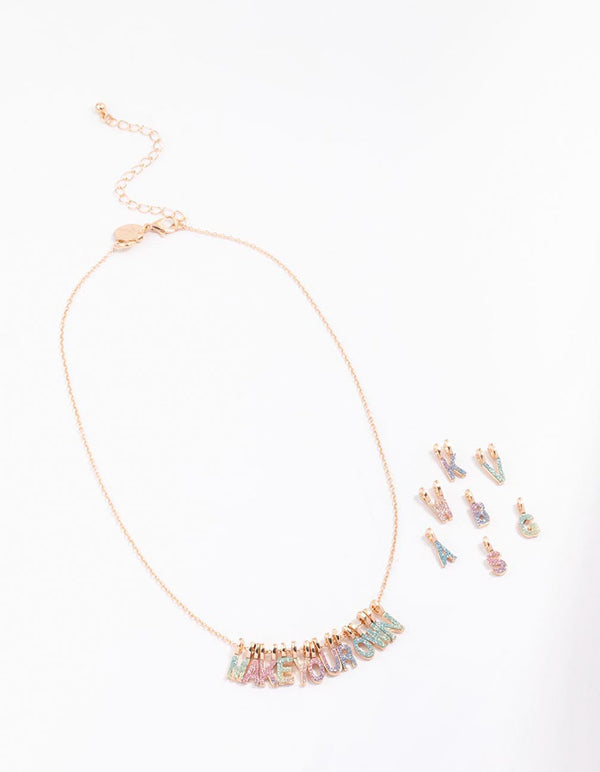Presenting a kids gold make your own DIY rainbow glitter charm necklace kit with initials in pink aqua and lavender front view