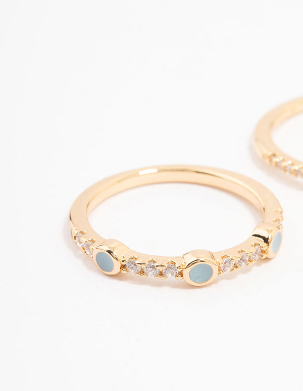 Showcasing gold plated oval bezel stacking rings with dainty design close up view