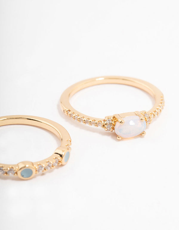 Showcasing gold plated oval bezel stacking rings with dainty design close up view