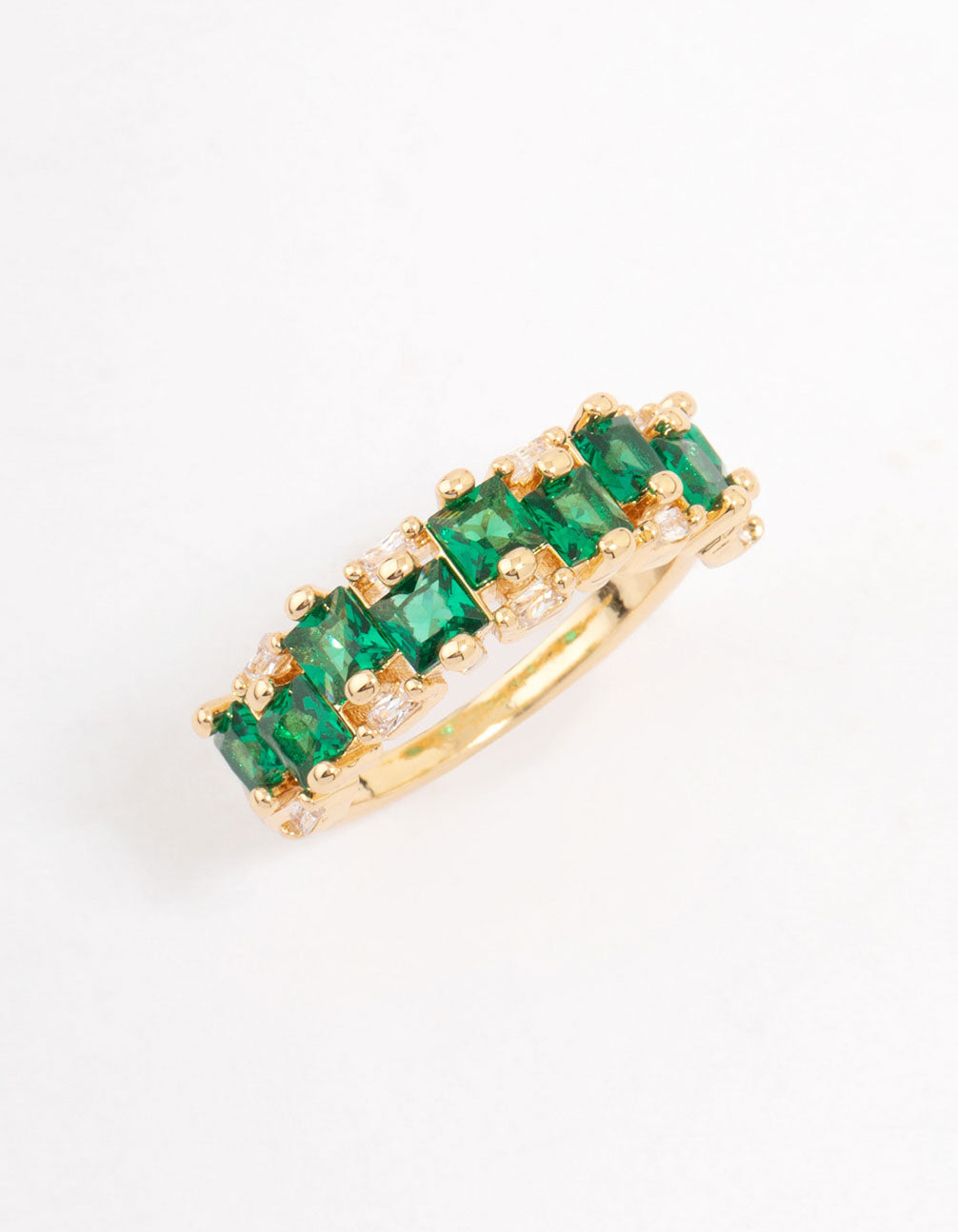 Elegant gold plated staggered band ring with emerald cut cubic zirconia in dark green side detail view