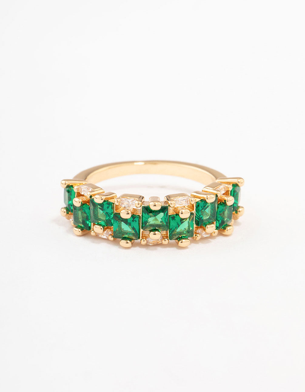 A gold plated staggered band ring crafted with emerald cut cubic zirconia in dark green close up view