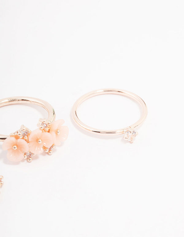 Featuring rose gold plated triple flower stacking ring pack in dainty style close up view