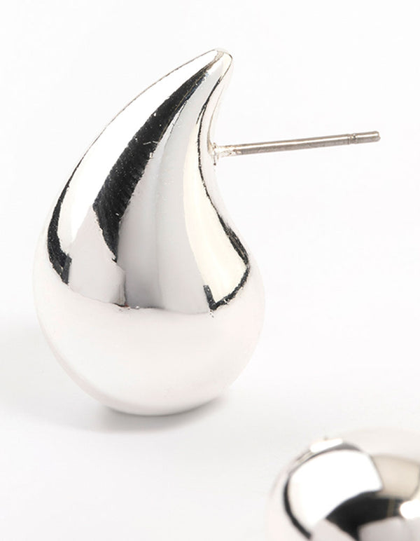 Featuring silver plated teardrop stud earrings with reflective metal craftsmanship close up view