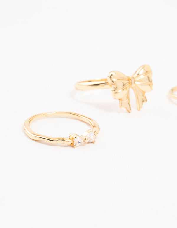Featuring gold plated bow and heart stackable rings with cubic zirconia in a 3-pack side detail view