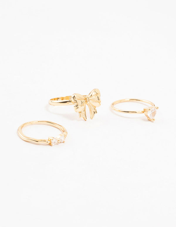 Showcasing gold plated bow and heart stackable rings with cubic zirconia in a 3-pack front view