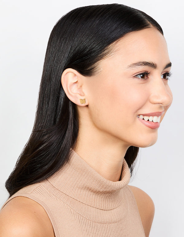 Crafted from waterproof gold plated stainless steel butterfly stud earrings with glitter texture on model view