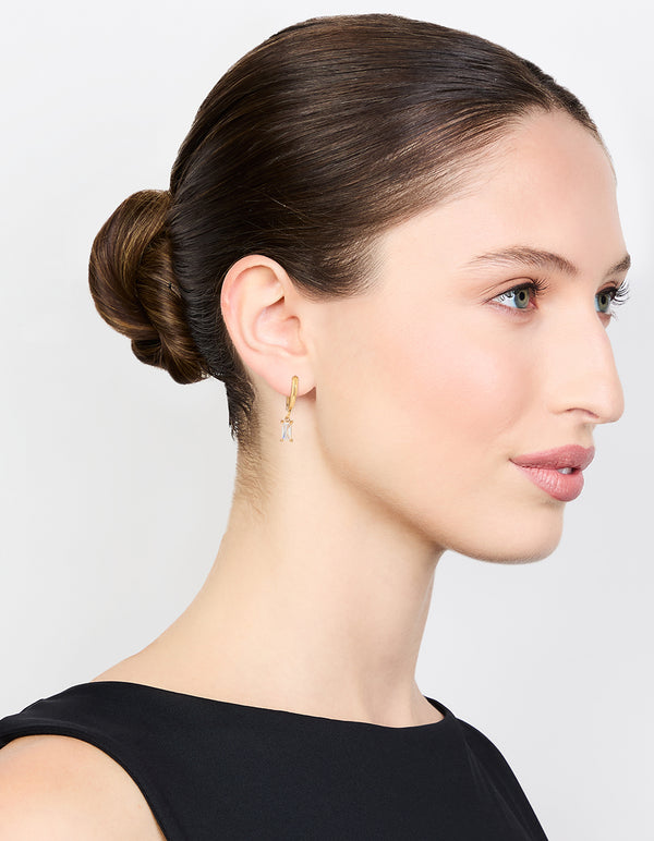 Displaying waterproof gold plated stainless steel baguette diamante huggie earrings on model view