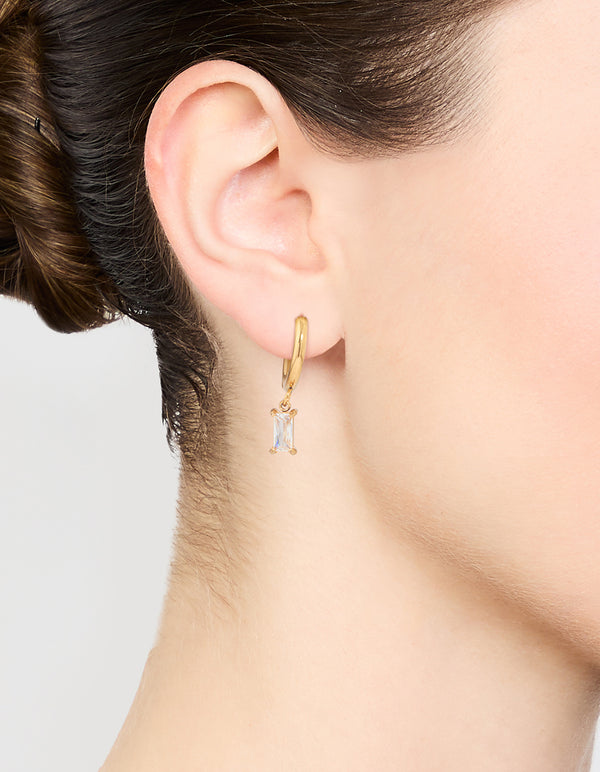 Showcasing waterproof gold plated stainless steel baguette diamante huggie earrings on ear view