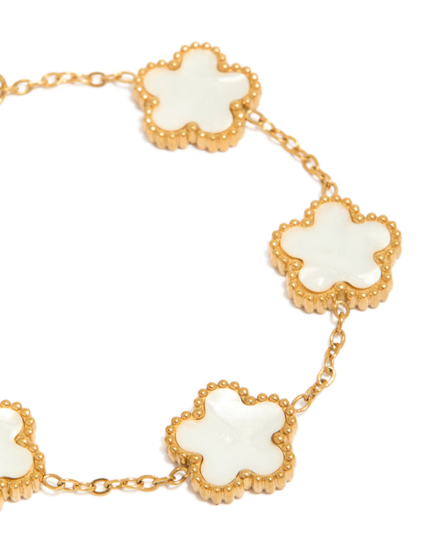 Showcasing waterproof gold plated stainless steel floral petal charm bracelet in white close up view