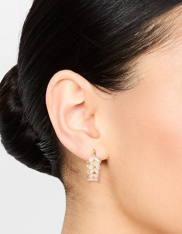 Showcasing gold plated cubic zirconia vine hoop earrings with crystal design in clear on ear view