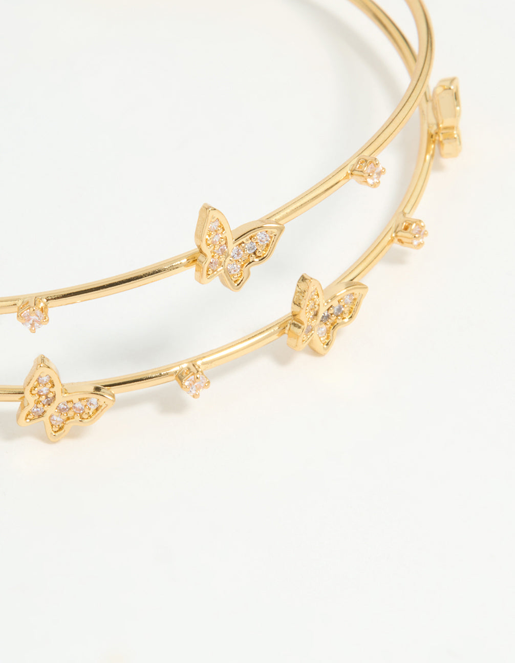 Presenting a gold plated mini butterfly wrist cuff close up view