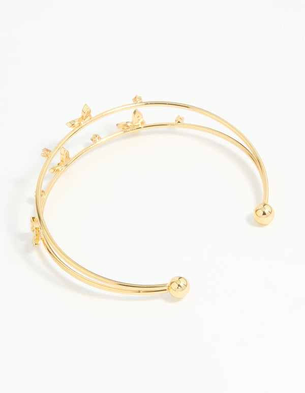 Featuring a gold plated mini butterfly wrist cuff closure detail view