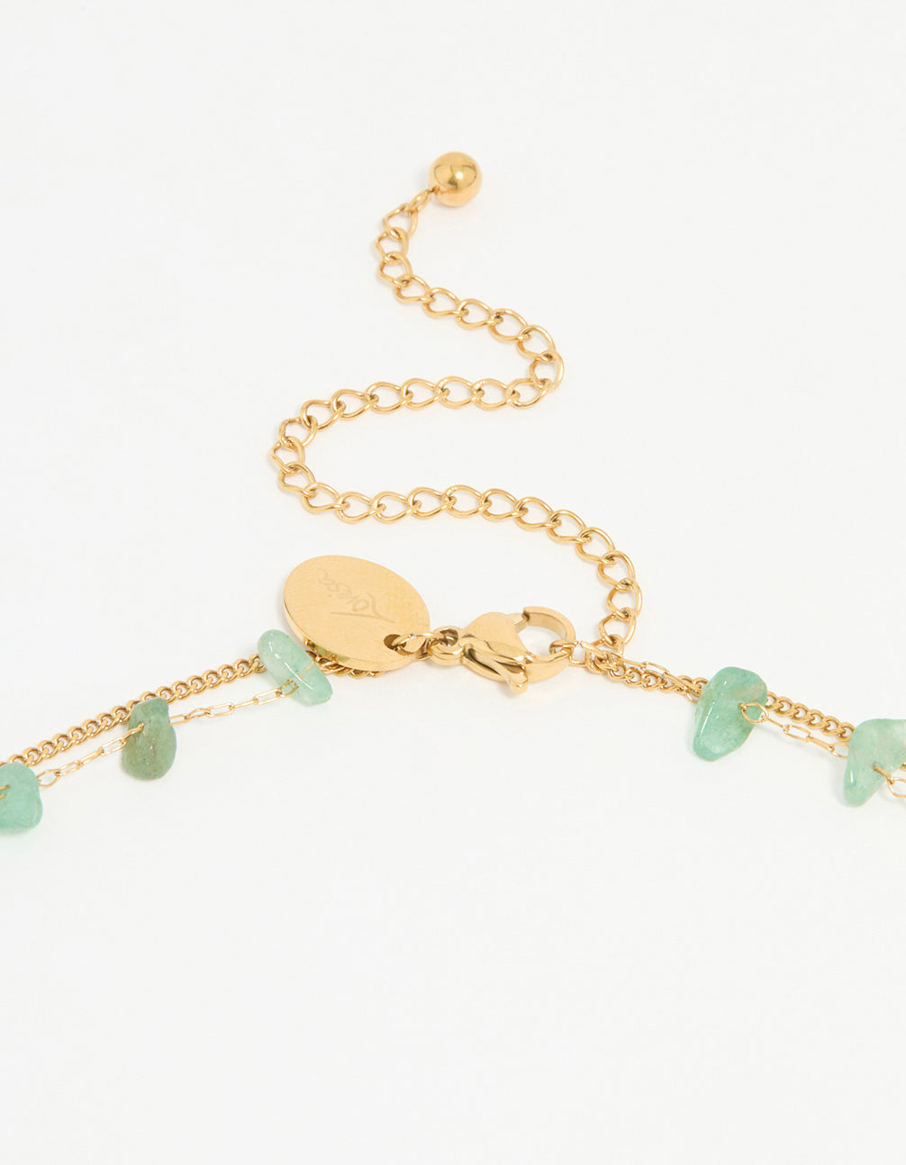 Designed with waterproof gold plated stainless steel, this layered necklace showcases green stone beads clasp detail view