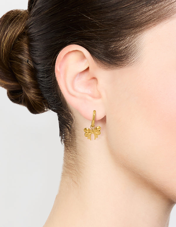 Showcasing bow hoop earrings in waterproof gold plated stainless steel on ear view
