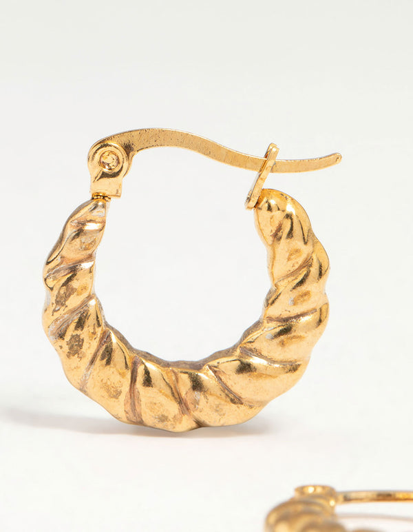 Crafted from waterproof gold plated stainless steel textured crescent hoop earrings with twist detail close up view