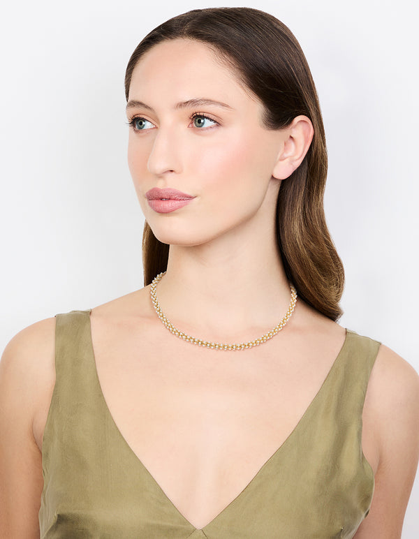 Crafted from gold plated material, this pearl fireball bracelet in white on model view