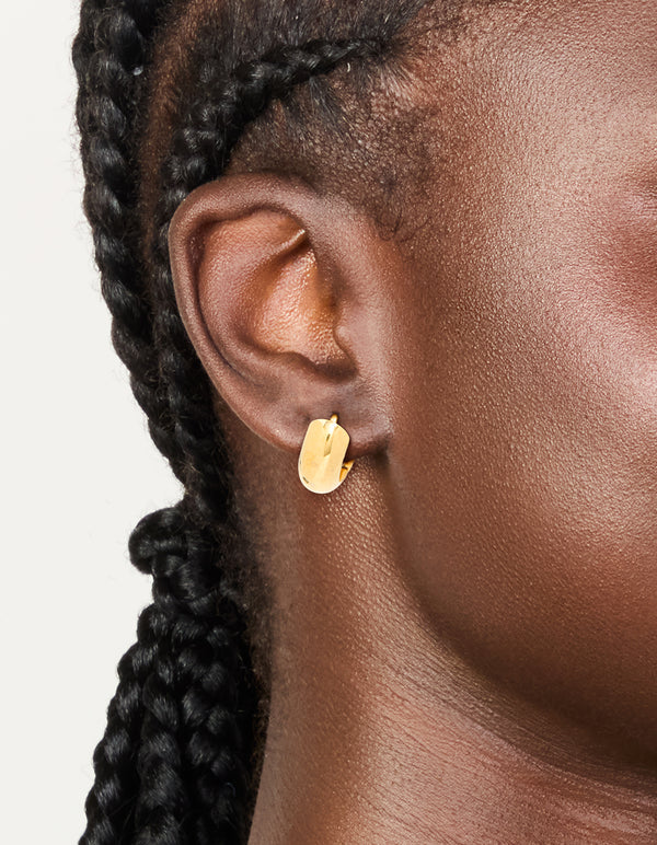 Featuring waterproof gold plated stainless steel chunky huggie earrings measuring 10 MM on ear view
