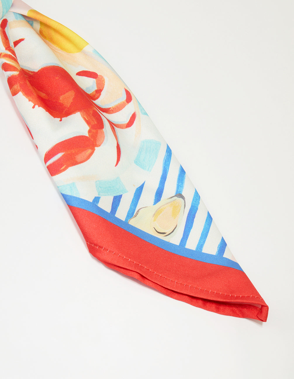 Beautifully crafted summer fabric scarf in novelty print featuring food, fruit, and ocean elements with tomato, dodger blue, gold, and pale turquoise colors side view