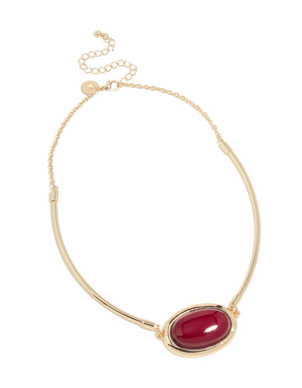 Displaying a gold necklace featuring red large stone and tube in crimson front view