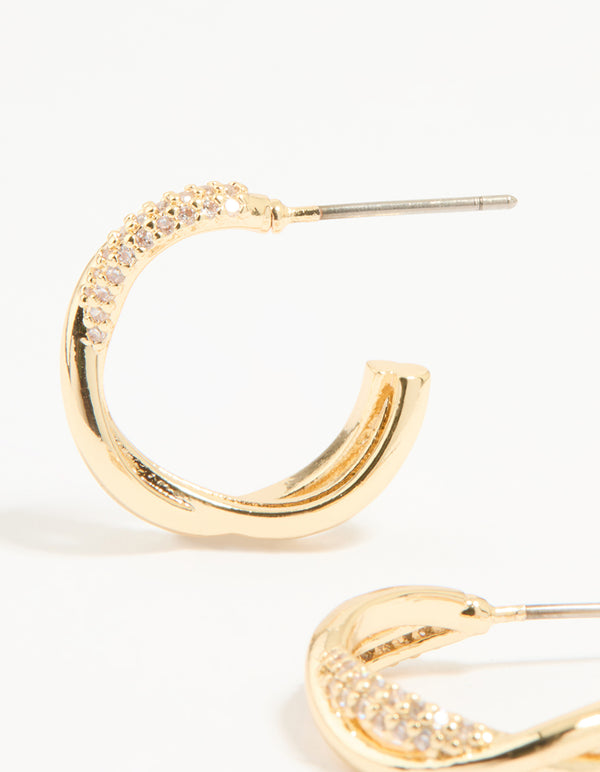 Highlighting statement hoop earrings in gold plated finish with cubic zirconia and twisted design close up view