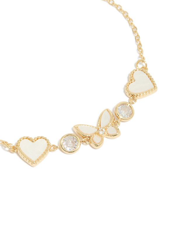 Presenting gold plated cubic zirconia butterfly and heart toggle bracelet close up view