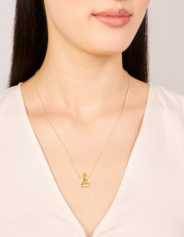 Showcasing waterproof gold plated stainless steel large bubble letter B initial pendant necklace on neck view
