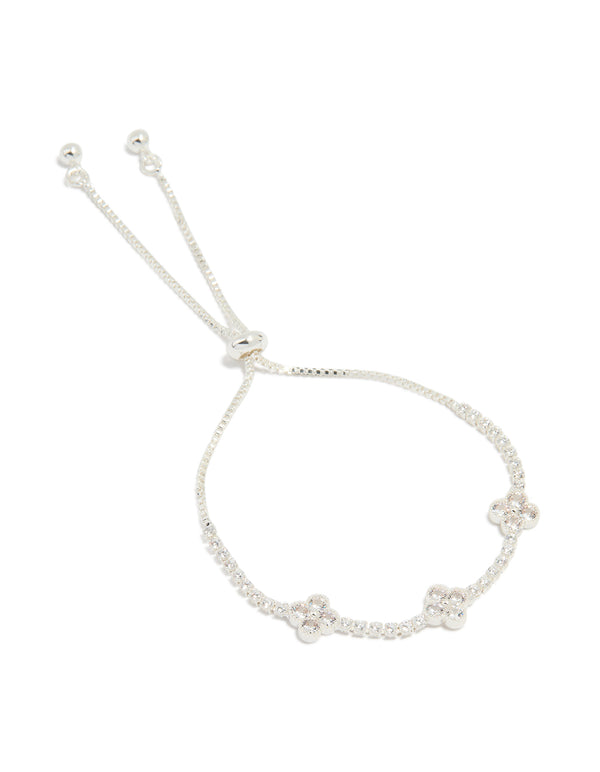 Showcasing a silver plated cubic zirconia flower station toggle bracelet in dainty style front view