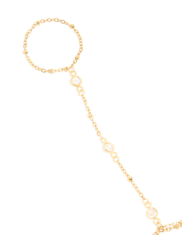 Featuring a waterproof gold plated stainless steel hand chain with cubic zirconia with gold beads in dainty style in close up view