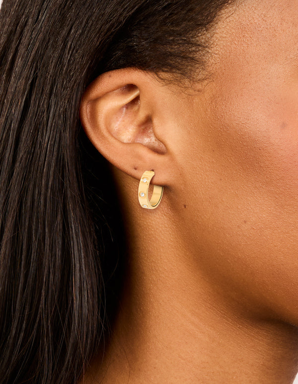 Showcasing waterproof gold plated stainless steel cubic zirconia square hoop earrings worn on ear view