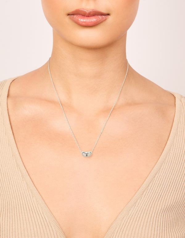 Featuring a pendant in silver plated material, this small pebble statement necklace shown on neck view