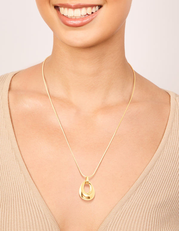 Showcasing a waterproof open oval pendant necklace in gold plated stainless steel on neck view