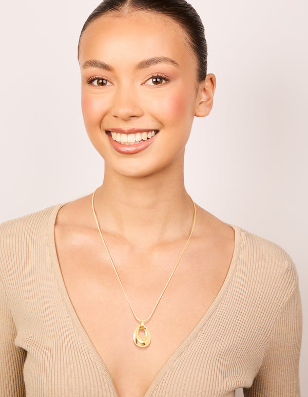 Designed with a waterproof open oval pendant necklace in gold plated stainless steel on model view