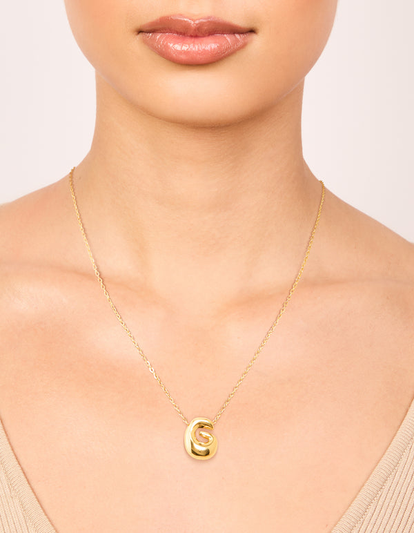 Crafted from waterproof gold plated stainless steel large bubble letter G necklace featuring a bold initial pendant on neck view