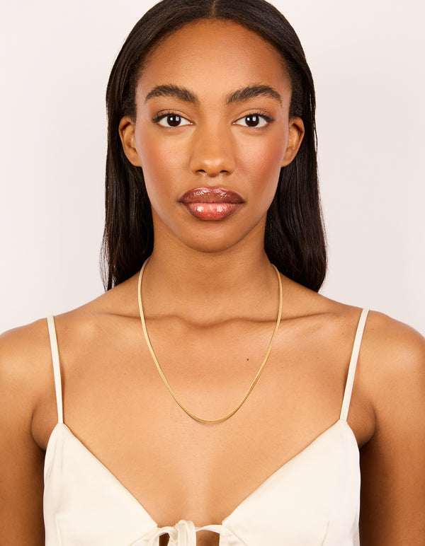 Presenting a waterproof snake short necklace designed with stainless steel featuring dainty style in gold plated finish on model view