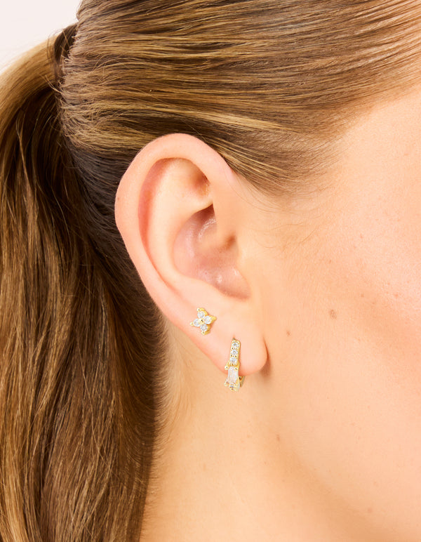 Showcasing gold plated cubic zirconia star huggie and hoop earrings in a 2-pack crystal clear design on ear view