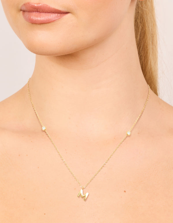 Beautifully designed waterproof letter M initial pendant necklace in gold plated stainless steel in dainty style on neck view