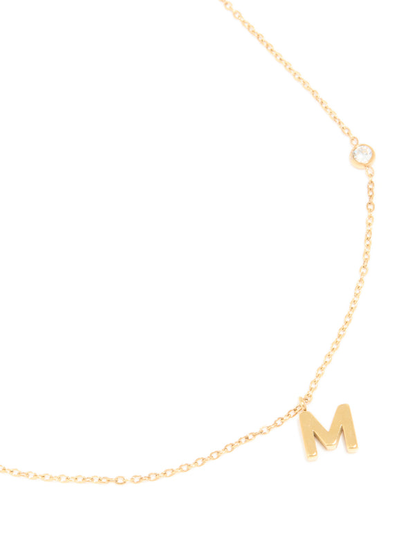 Showcasing a waterproof letter M initial pendant necklace crafted from gold plated stainless steel in dainty style close up view