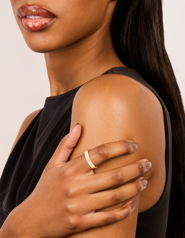 Designed with waterproof mixed metals plated stainless steel skinny cubic zirconia dot rings in gold and silver, shown in a 2-pack on finger view