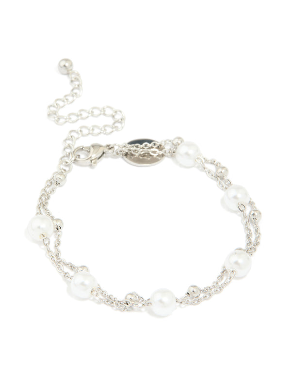 Featuring a waterproof stainless steel pearl and ball layered bracelet in white and silver front view