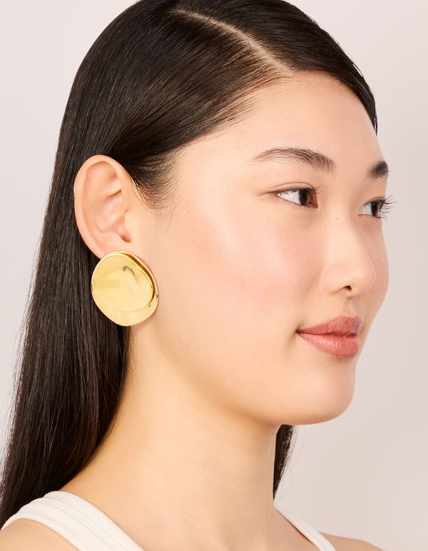 Designed with waterproof gold plated stainless steel double crinkle disc stud earrings on model view