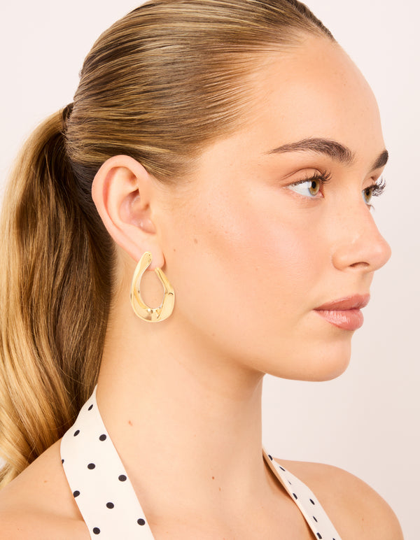 Featuring waterproof gold plated stainless steel organic teardrop stud earrings on model view