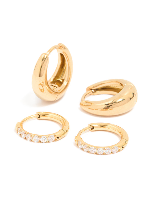 Featuring waterproof cubic zirconia chubby huggie earrings set in gold plated stainless steel with clear accents front view