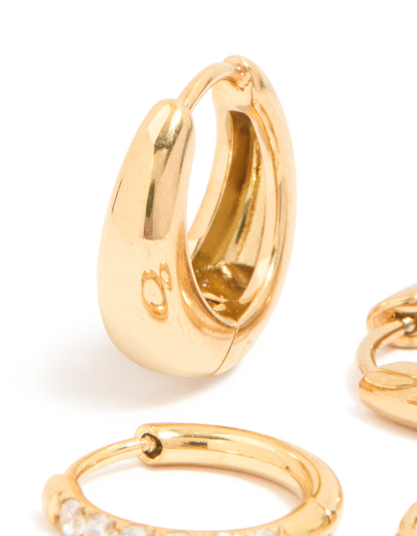 Highlighting waterproof cubic zirconia chubby huggie earrings set crafted from gold plated stainless steel with clear accents close up view