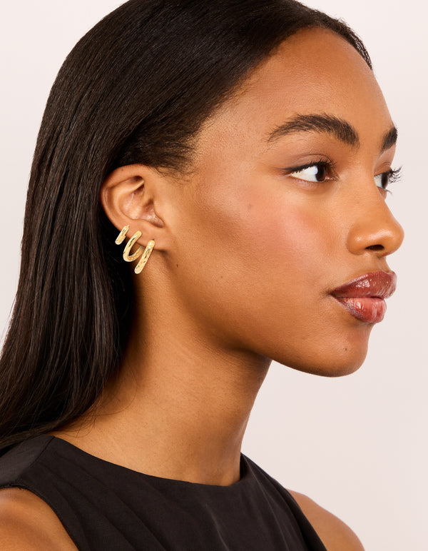 Crafted from waterproof gold plated stainless steel mixed detail huggie earrings in a 3-pack on model view