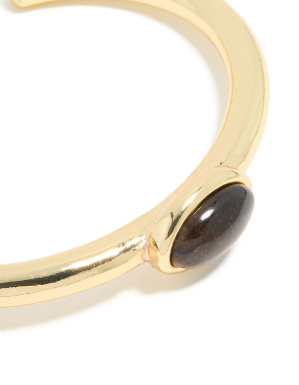 Designed with waterproof gold plated stainless steel, this open wrist cuff highlights the tigers eye semi precious stone setting close up view