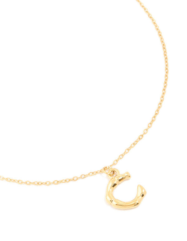 Showcasing a waterproof letter C necklace in bamboo style, crafted from gold plated stainless steel close up view
