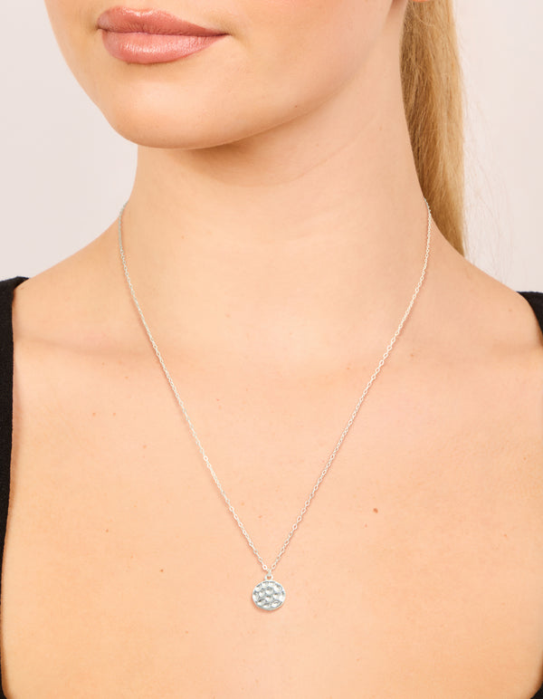 Showcasing a sterling silver molten round pendant necklace on neck view
