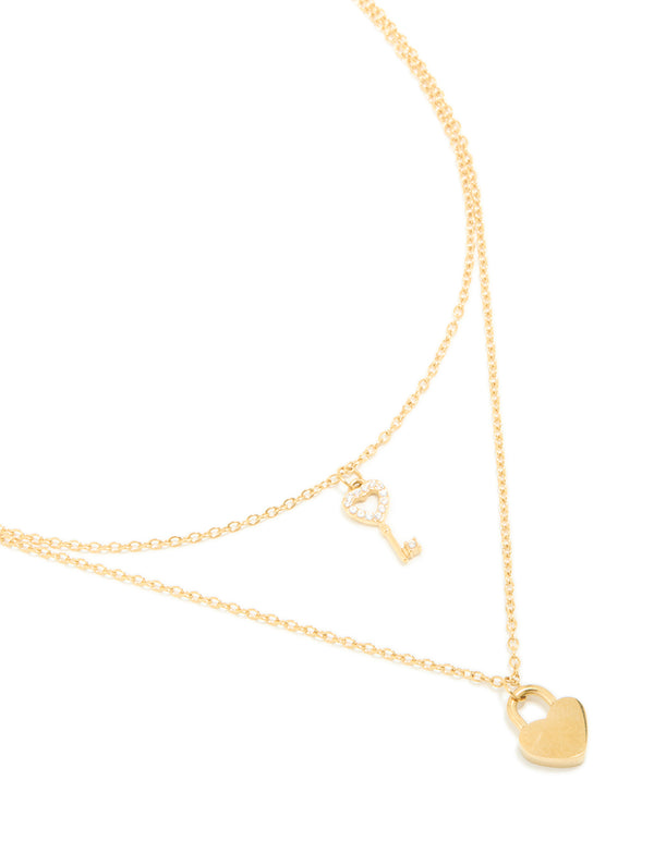 Showcasing a dainty waterproof heart padlock and key pendant layered necklace crafted from gold plated stainless steel close up view